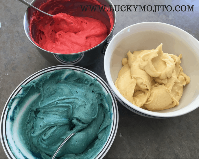 rainbow cookie dough divided into three bowls