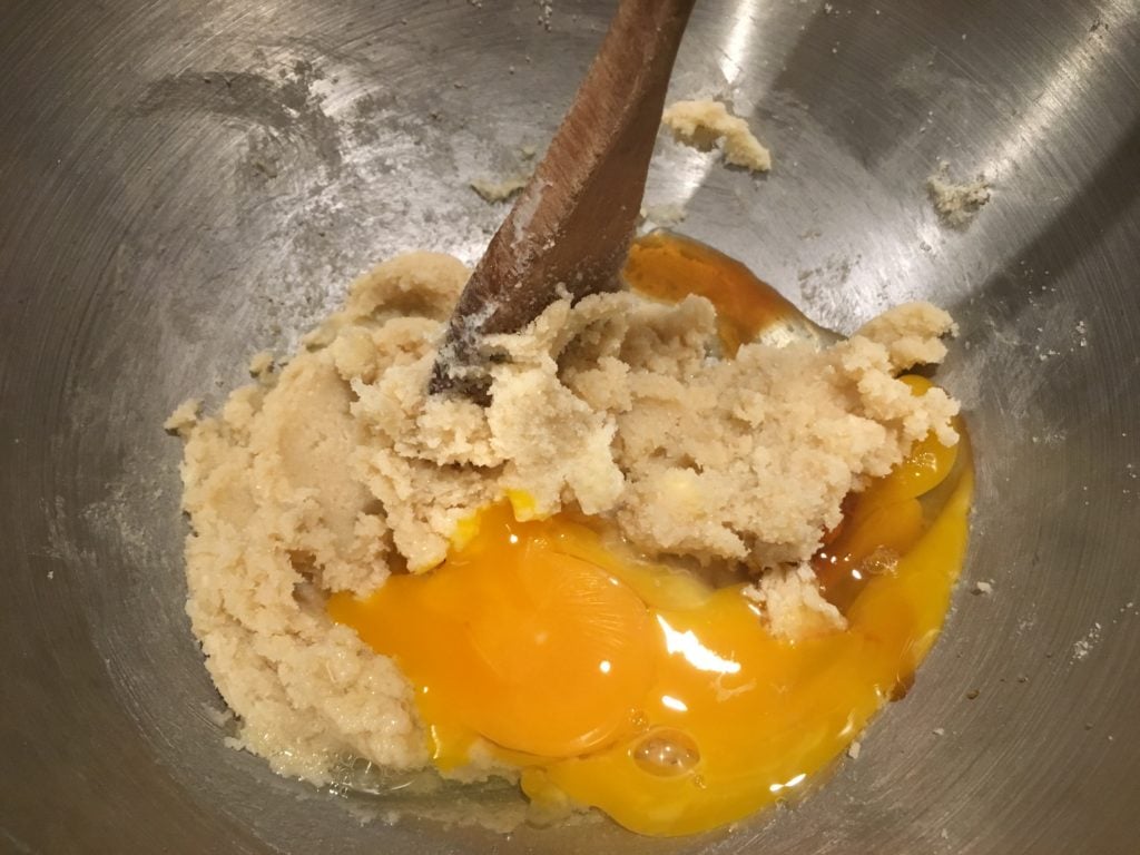 adding eggs to cookie dough