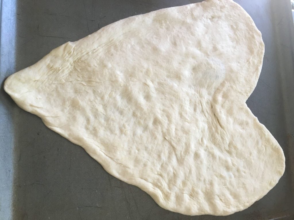 rolling out heart shaped dough for pizza